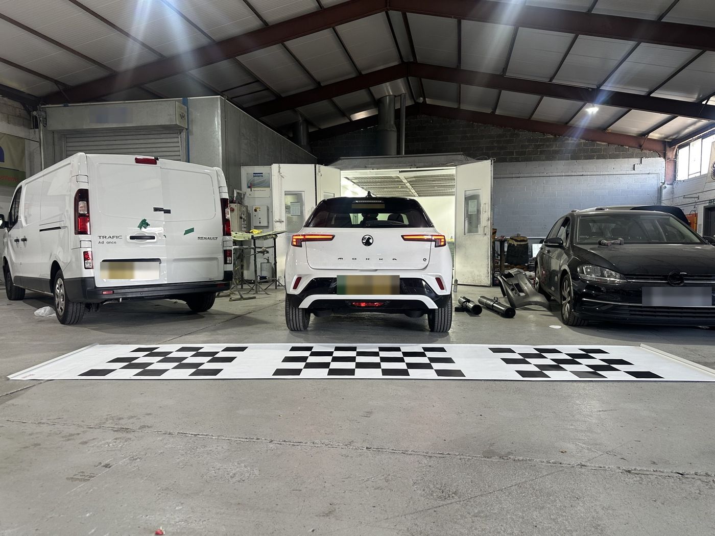 Rear camera calibration mats laid out behind the car in Sheffield