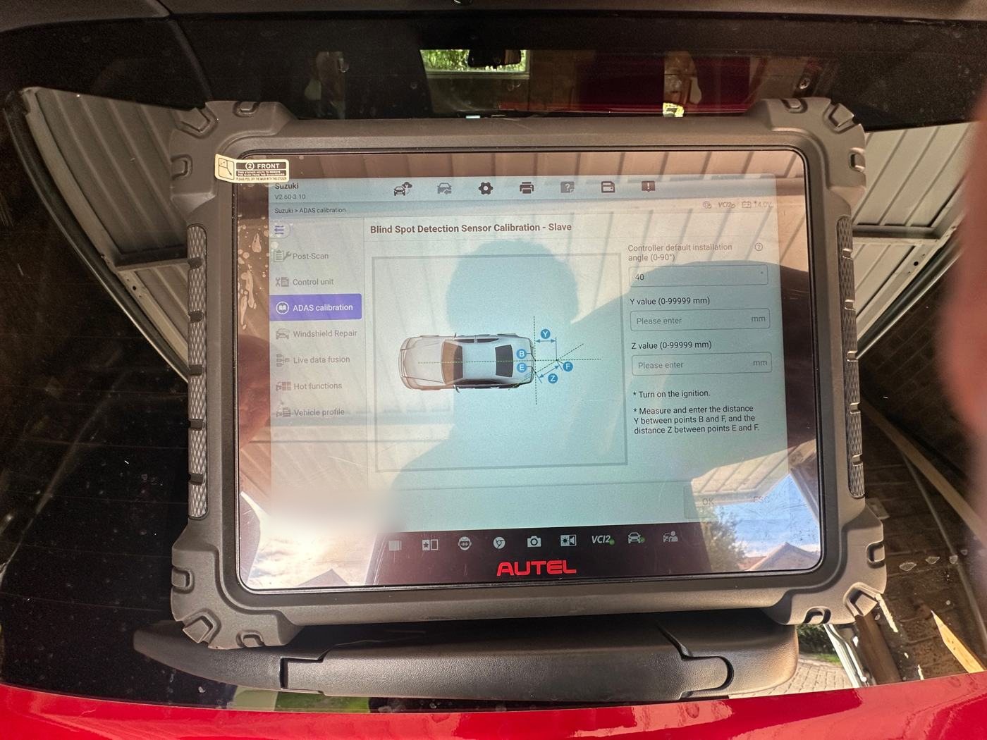 Diagnostic tablet running a blind-spot detection sensor calibration