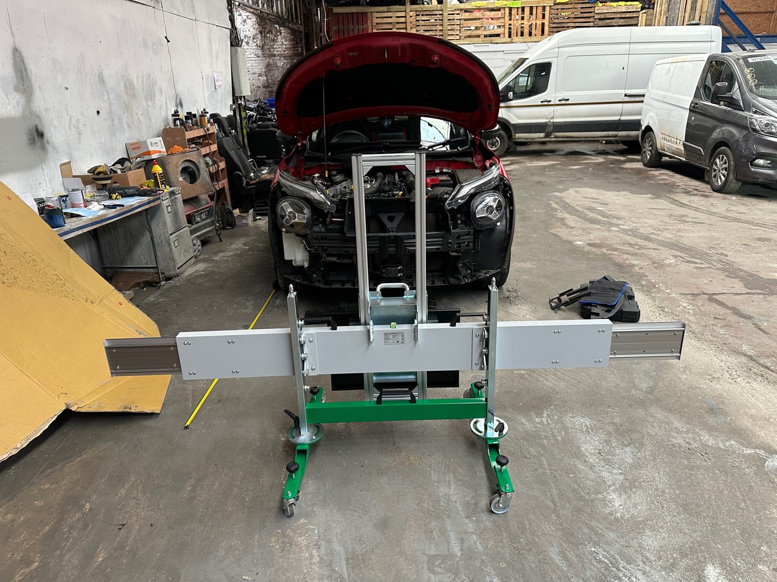 Calibration rig centred on a car with its front end stripped after collision repair in Sheffield