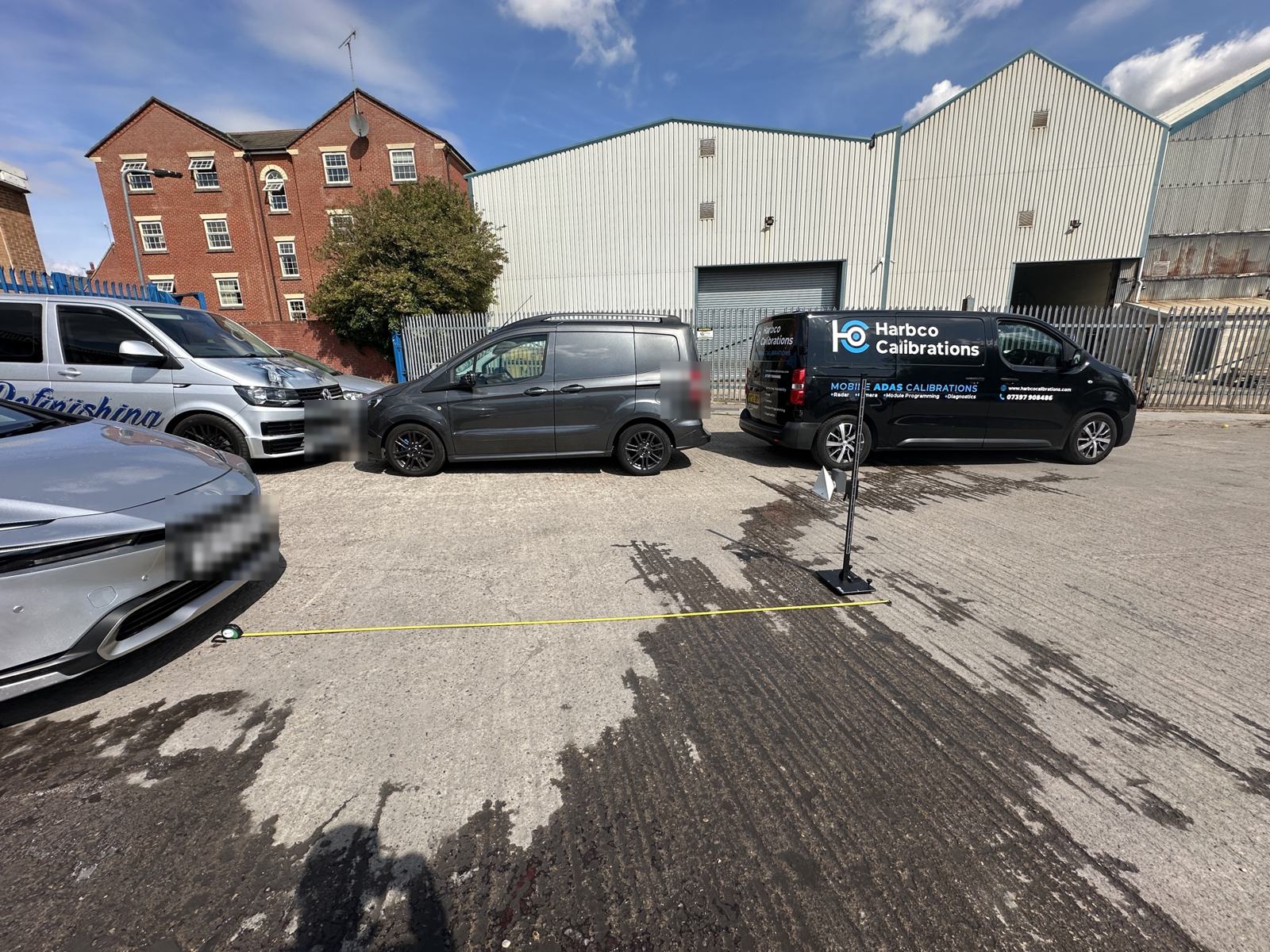 Radar reflector stand measured out in front of a car in a trade customer's yard, Harbco van behind in Barnsley