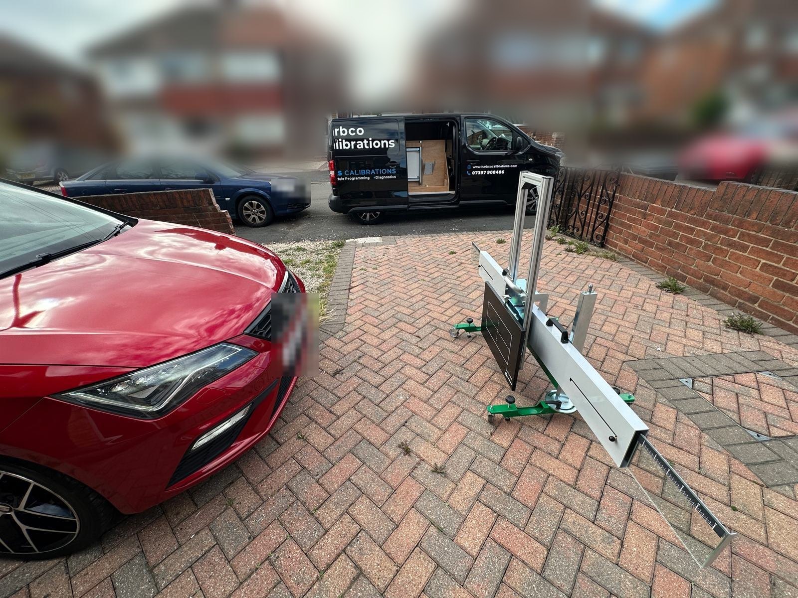 Radar calibration rig set up on a customer's block-paved drive, with the Harbco van parked on the road behind in Doncaster
