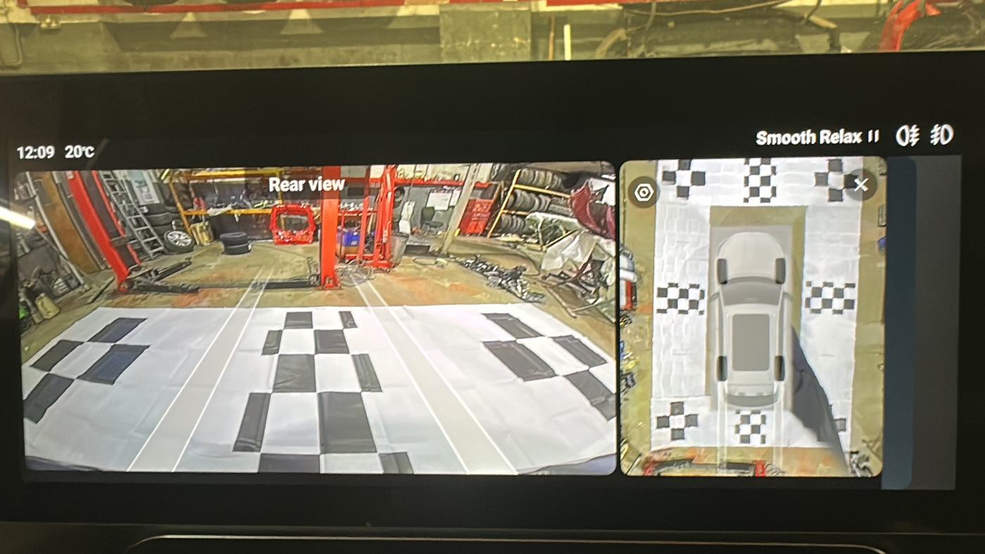 Infotainment screen showing a 360-degree camera calibration over checkerboard mats in Nottingham