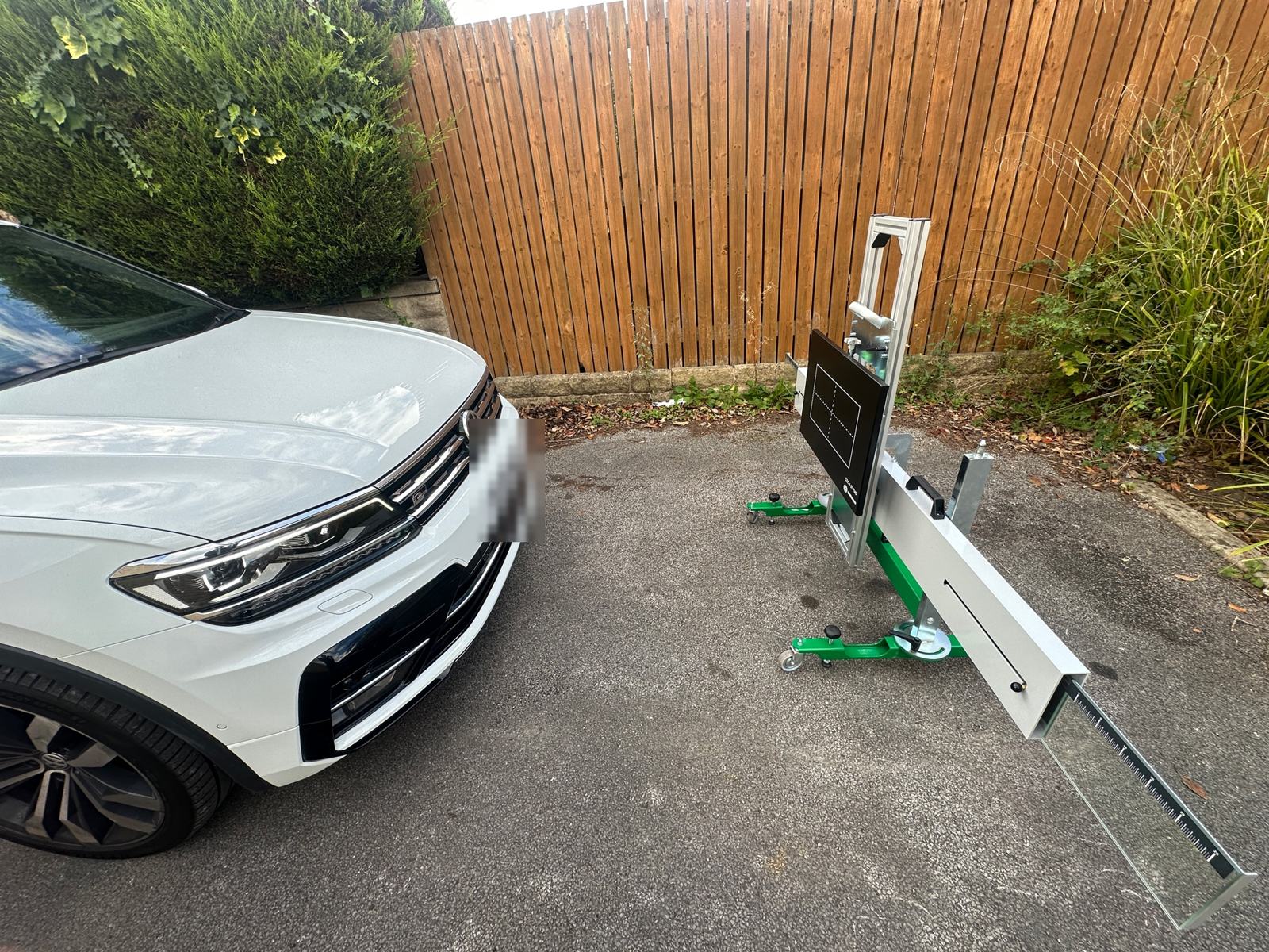 White VW Tiguan on a driveway with a camera calibration rig set up in front in Sheffield